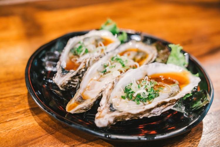 three oysters on a plate