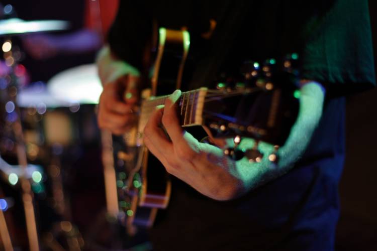 person playing guitar on stage