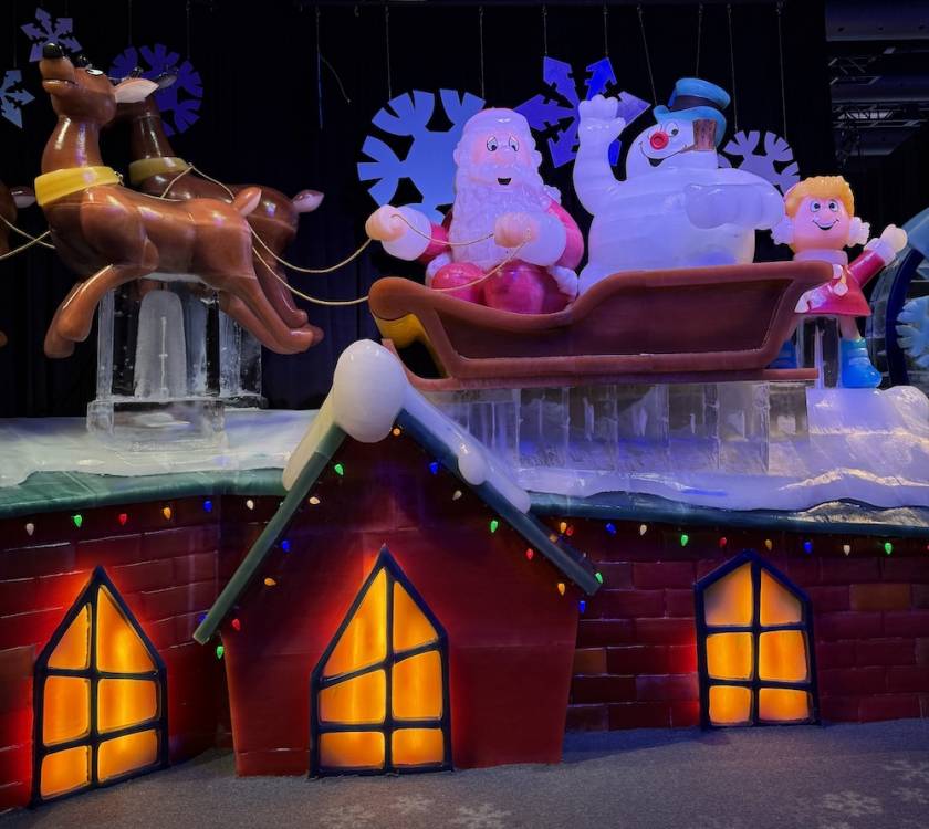 Ice sculpture of a house and santa with frosty the snowman